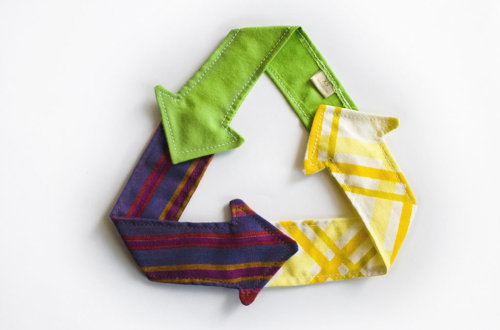 Recycle three arrow logo recreated using textiles as arrows.
