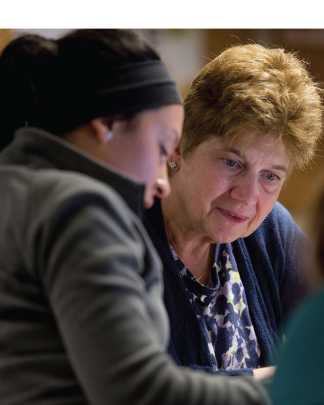 A student and a Career Services advisor sitting closely together in a friendly conversation