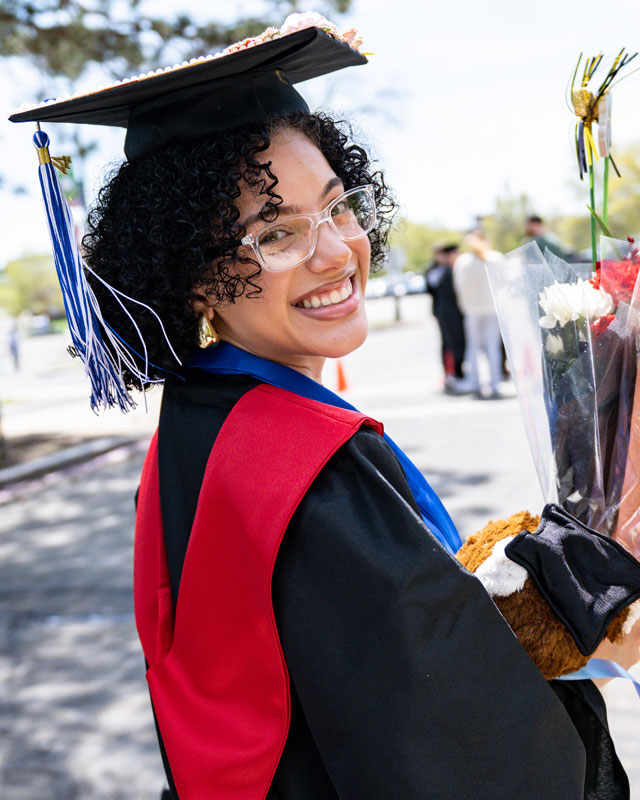 Portrait of NSCC female graduate smiling holding flowers