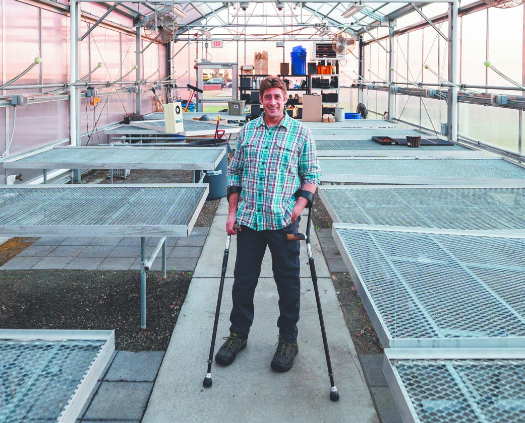 Mark Priest in Lynn campus greenhouse
